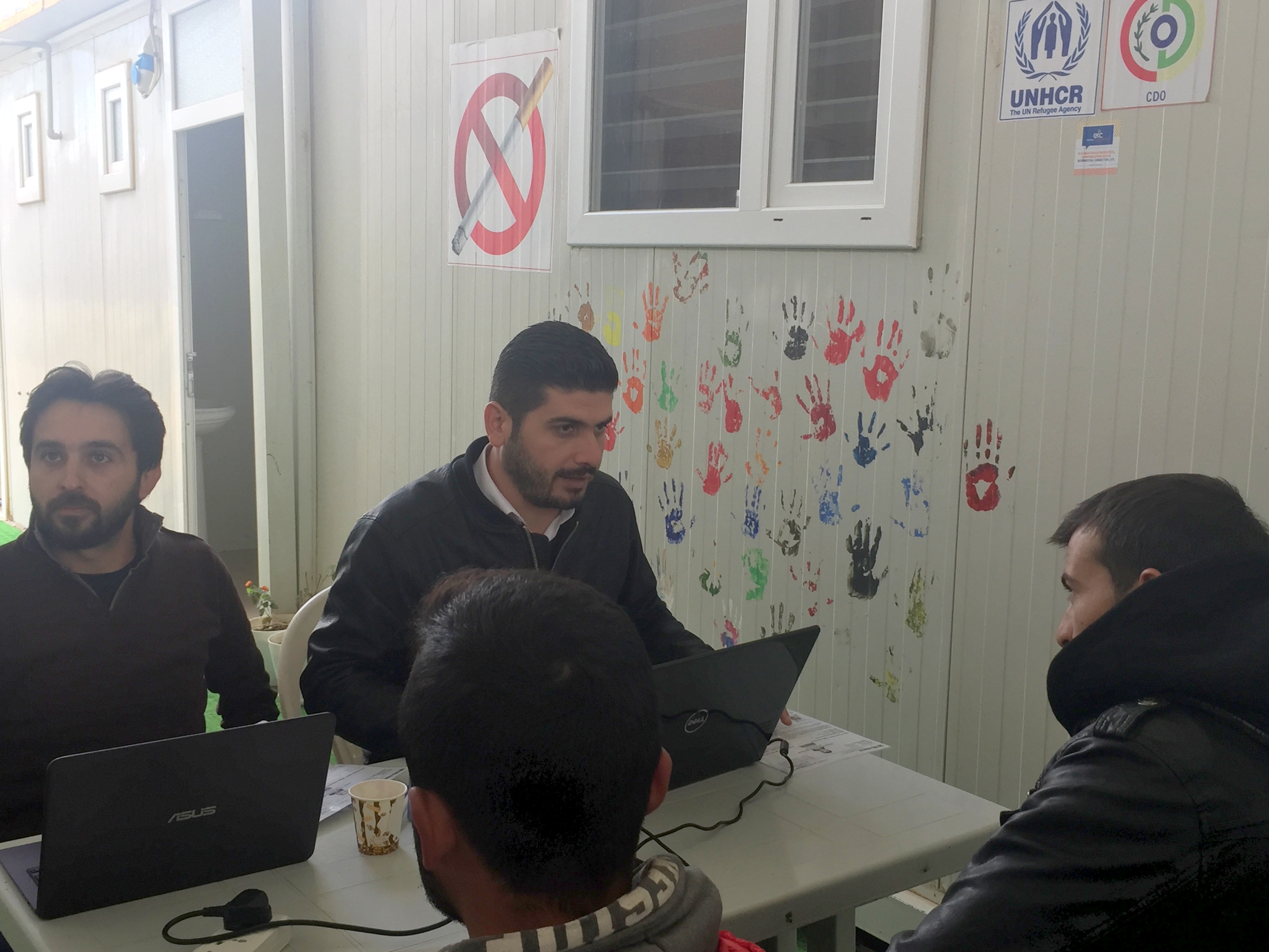Syrians being registered before taking the online entry exam.