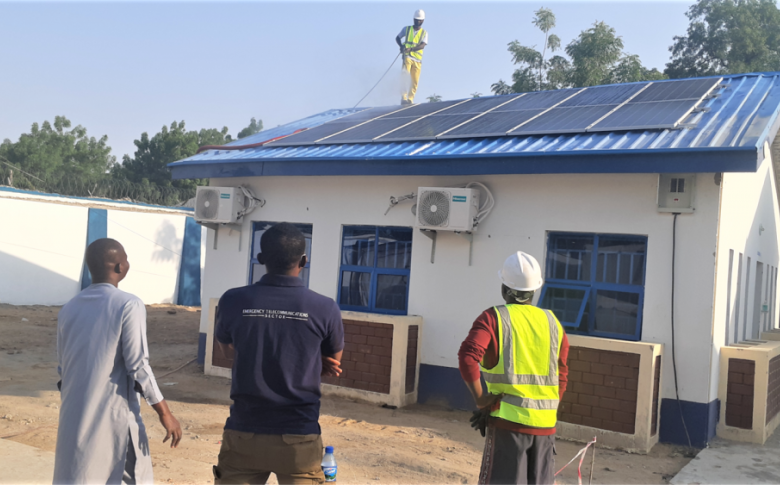 The ETS and contractors inspect the newly installed solar-powered hybrid system in Bama