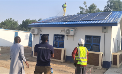 The ETS and contractors inspect the newly installed solar-powered hybrid system in Bama